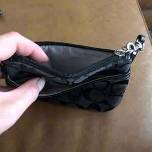 Black COACH wristlet about 7 inches long